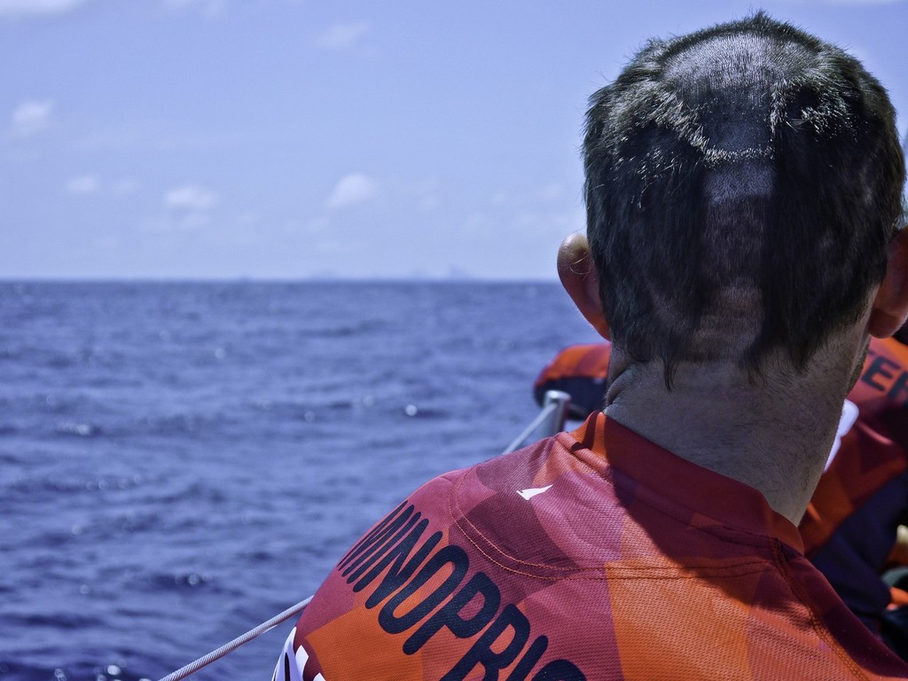 Adam Minoprio with the scars of his first equator crossing as he looks onto Fernando Island onboard CAMPER with Emirates Team New Zealand during leg 1 of the Volvo Ocean Race 2011-12, from Alicante, Spain to Cape Town, South Africa.  © Hamish Hooper/Camper ETNZ/Volvo Ocean Race