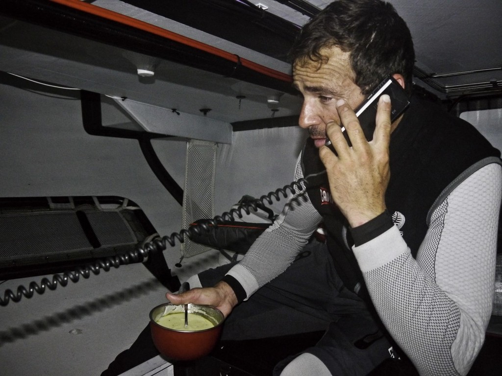 Roberto Bermudez de Castro takes a media call while eating between watches onboard CAMPER with Emirates Team New Zealand © Hamish Hooper/Camper ETNZ/Volvo Ocean Race