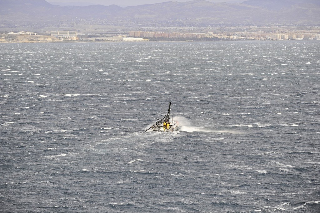 Abu Dhabi Ocean Racing’s yacht Azzam, skippered by Britain’s Ian Walker, returns to Alicante, Spain after the mast broke in rough weather on the first day of racing on leg 1 of the Volvo Ocean Race 2011-12.  © Paul Todd/Volvo Ocean Race http://www.volvooceanrace.com