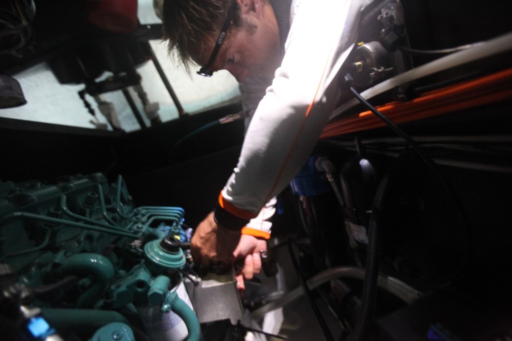 Thomas Coville making repairs to the engine which drives the canting keel, onboard Groupama Sailing Team in the Rolex Fastnet Race. © Volvo Ocean Race http://www.volvooceanrace.com