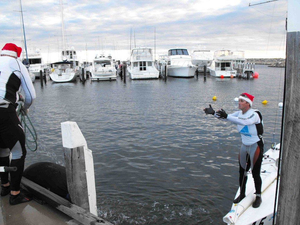 Richard and Tyler were in the Christmas spirit today with the Santa hats for the trip into the harbour. - ISAF Sailing World Championships Perth 2011 © John Curtis
