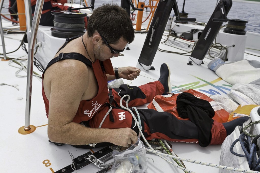 Jared Henderson maintains an often used furling line.Team Sanya during leg 2 of the Volvo Ocean Race 2011-12, from Cape Town, South Africa to Abu Dhabi, UAE. (Credit: Andres Soriano/Team Sanya/Volvo Ocean Race) © Andres Soriano/Team Sanya/Volvo Ocean Race