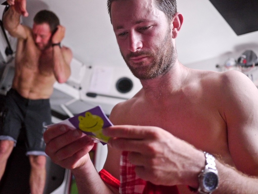Adam Minoprio reads a christmas card from his girlfriend onbaord Camper © Hamish Hooper/Camper ETNZ/Volvo Ocean Race