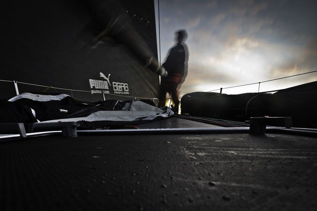 Casey Smith working on the foredeck during a sunrise sail change. Puma Ocean Racing during leg 2 of the Volvo Ocean Race 2011-12, from Cape Town, South Africa to Abu Dhabi, UAE.  © Amory Ross/Puma Ocean Racing/Volvo Ocean Race http://www.puma.com/sailing