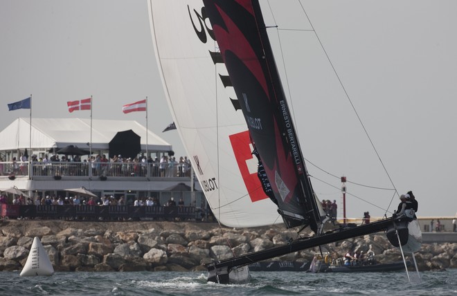 Alinghi flying in front of the crowds of spectators at the race village in The Wave, Muscat - Extreme Sailing Series 2012. Act 1 &copy; Lloyd Images http://lloydimagesgallery.photoshelter.com/