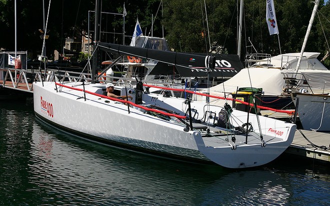 Dee Smith grabs a bit of Vitamin D before we go sailing. Solid chines very evident in hull form. - Farr 400 ©  John Curnow