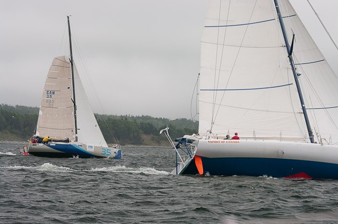 Derek Hatfield’s  Open 60 “Spirit of Canada” and “Bleu-Salin’eau” head out to sea at the start of Route Halifax Saint-Pierre 2010.  © Derek Mason Photography