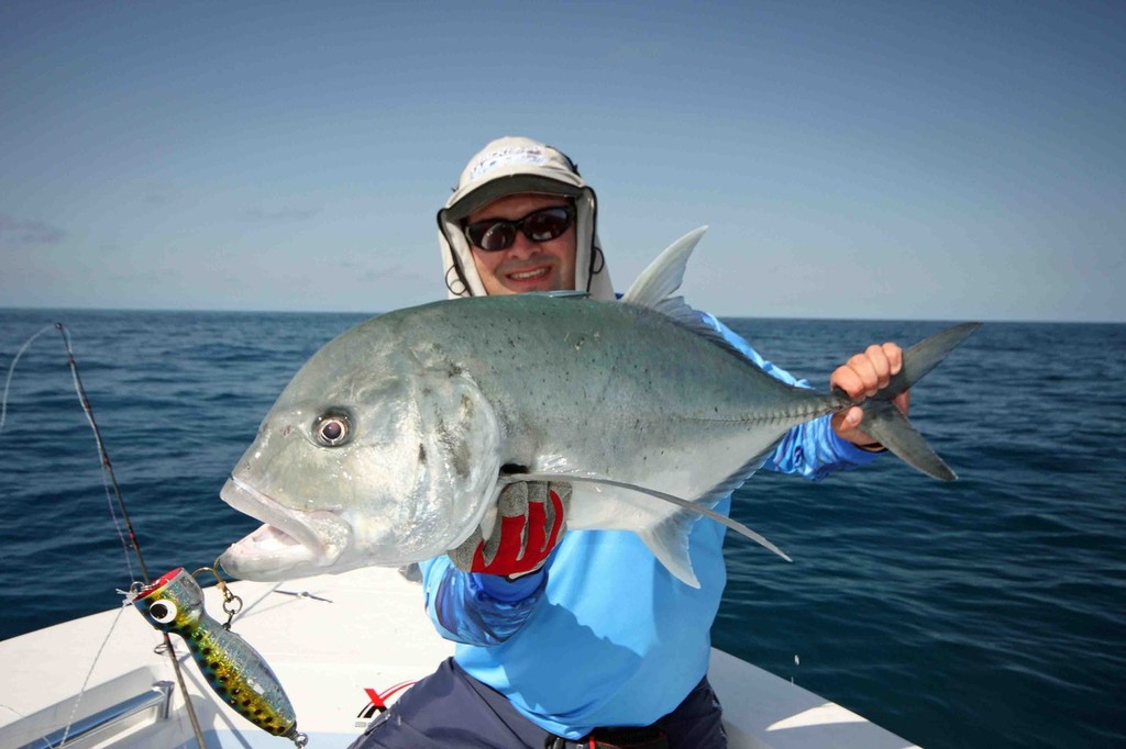 The grand prize of fishing the reef, a popper engulfing Giant Trevally. © Jarrod Day
