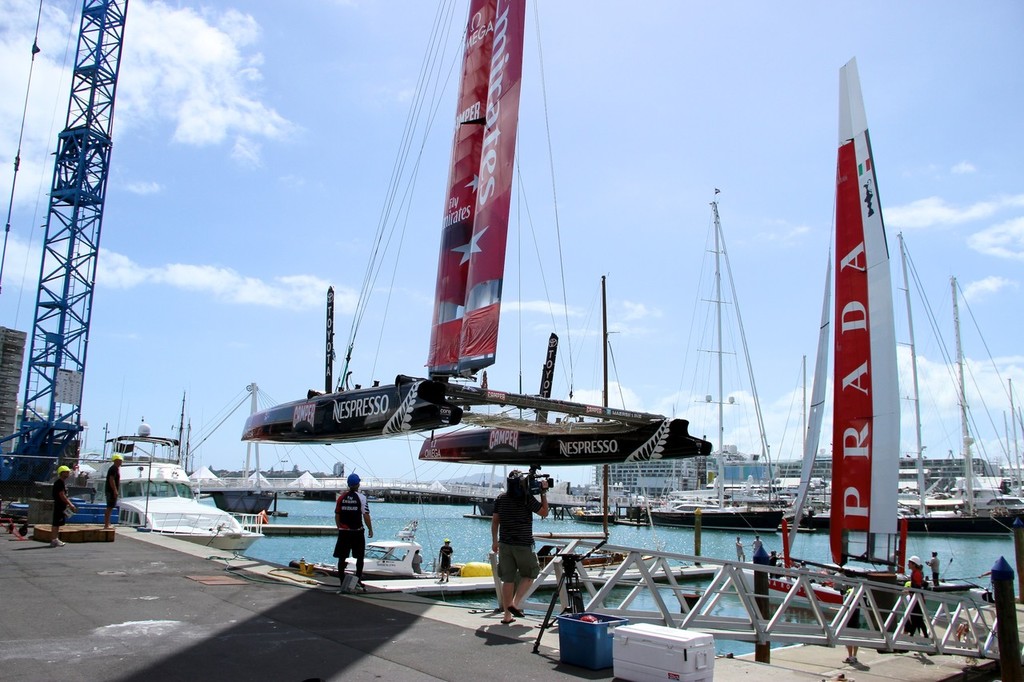 Emirates Team NZ&rsquo;s AC72 is craned into the water with Luna Rossa already launched, both feature the new top wingsail section photo copyright Richard Gladwell www.photosport.co.nz taken at  and featuring the  class