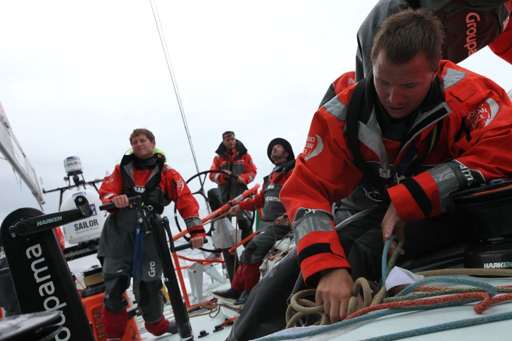 Day 1 - Jour 1 - Franck Cammas helming, Charles Caudrelier grinding, Damian Foxall with the mainsail and Martin Strömberg as pitman - Volvo Ocean Race 2011-12 photo copyright Yann Riou/Groupama Sailing Team /Volvo Ocean Race http://www.cammas-groupama.com/ taken at  and featuring the  class