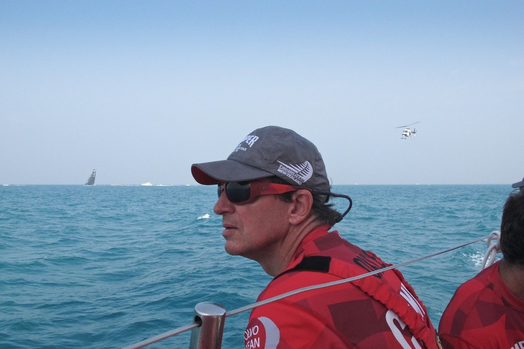Navigator Will Oxley with Abu Dhabi & TV helicopter as we set off leaving Abu Dhabi stop over behind onboard Camoer with Emirates Team New Zealand during leg 3 of the Volvo Ocean Race 2011-12, from Cape Town, South Africa to Abu Dhabi, UAE.  © Hamish Hooper/Camper ETNZ/Volvo Ocean Race