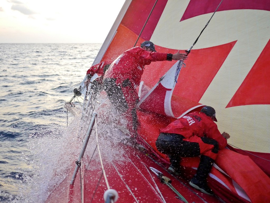 Mike Pammenter, Daryl Wislang and Chris Nicholson making a sail change on the foredeck of CAMPER with Emirates Team New Zealand during leg 3 of the Volvo Ocean Race 2011-12, from Abu Dhabi, UAE to Sanya, China.  © Hamish Hooper/Camper ETNZ/Volvo Ocean Race
