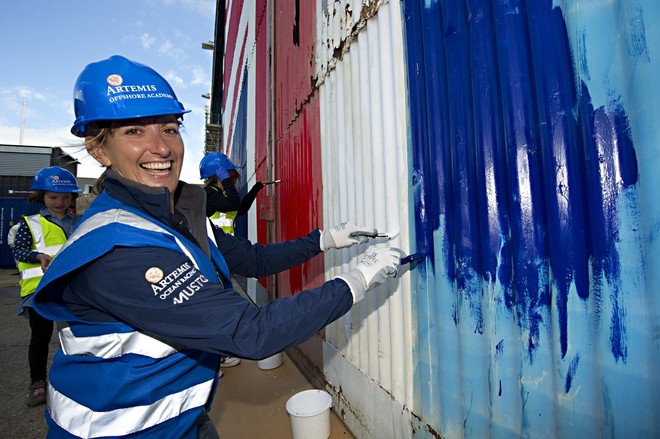 Record breaking offshore sailor Dee Caffari marks a truly British year by painting the giant Union Jack doors at the home of the Artemis Offshore Academy.  © Lloyd Images http://lloydimagesgallery.photoshelter.com/