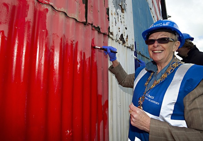East Cowes Mayoress Jane Rann makes her mark on the door before thanking the Artemis Offshore Academy for restoring the flag on behalf of the town.  © Lloyd Images http://lloydimagesgallery.photoshelter.com/