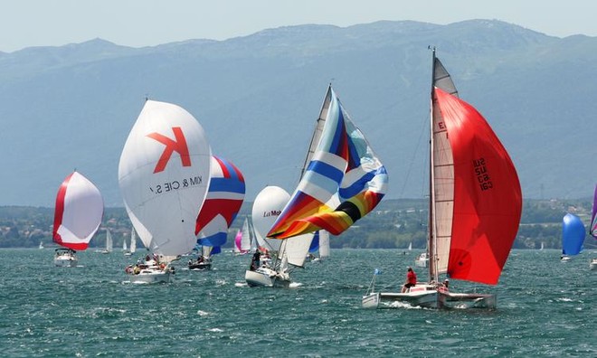 Our boat, Calopteryx with the red spinnaker passing in front of Nernier. (Picture by Vial) - Bol d’Or Mirabeaud 2012 © Jean Philippe Jobé
