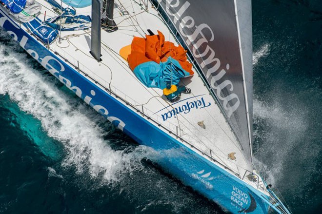 Team Telefonica, pulling down a sail, at the start of leg 8 from Lisbon, Portugal to Lorient, France, during the Volvo Ocean Race 2011-12.  &copy; Paul Todd/Volvo Ocean Race http://www.volvooceanrace.com