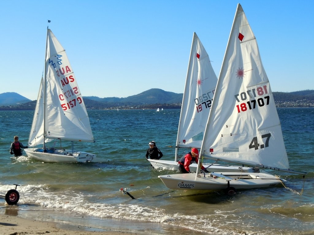 In the water at Nutgrove Beach,  the Oliver Burnell and Sam Tiedemann with their 420 and Laser 4.7 sailors Maddie Davies and Maddie Salter - Tasmanian Schools Regatta and Youth Championship 2012 © Stephen Spaulding