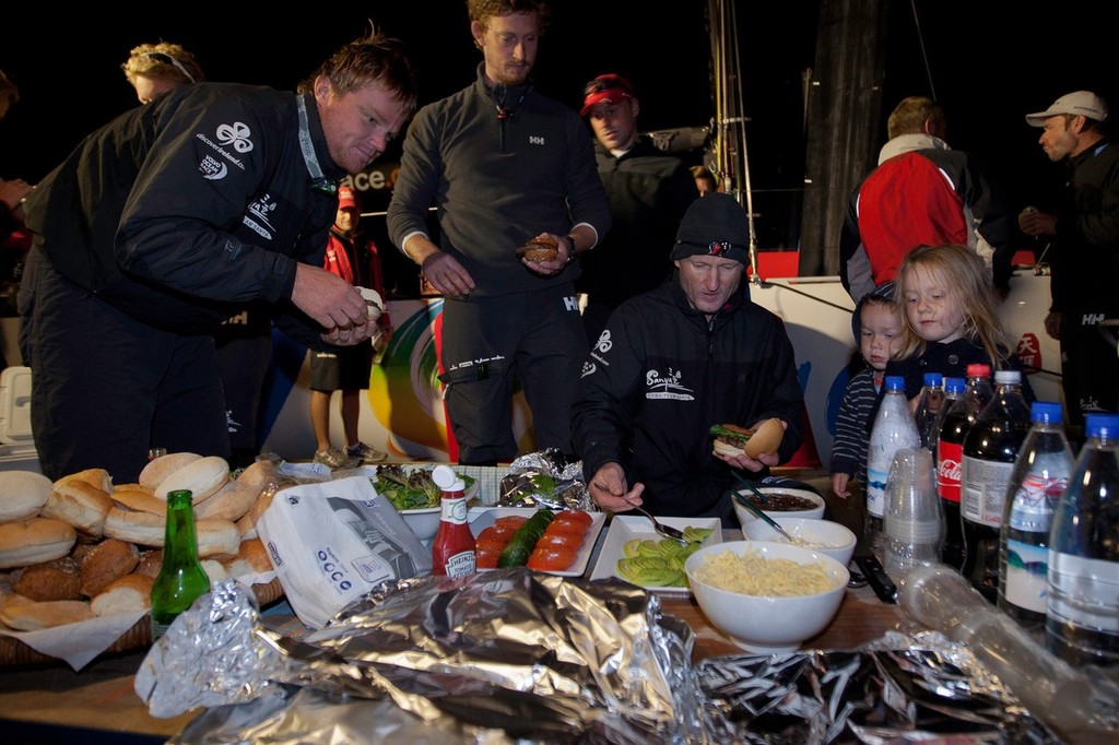 Team Sanya skippered by Mike Sanderson from New Zealand, are welcomed with burgers on the dock in Tauranga, New Zealand, after a broken rudder and hull damage forced them to sail back, during leg 5 of the Volvo Ocean Race 2011-12, from Auckland, New Zealand to Itajai, Brazil. They are now forced to retire from leg five and miss leg six of the race and ship their race boat and equipment to Miami. (Credit: Gareth Cooke/Volvo Ocean Race) photo copyright Gareth Cooke/Volvo Ocean Race http://www.volvooceanrace.com taken at  and featuring the  class