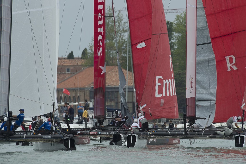 The fleet attempt to sqeeze between a mark and the sea wall in the final fleet race. America’s Cup World Series Regatta Venice.  © Chris Cameron/ETNZ http://www.chriscameron.co.nz
