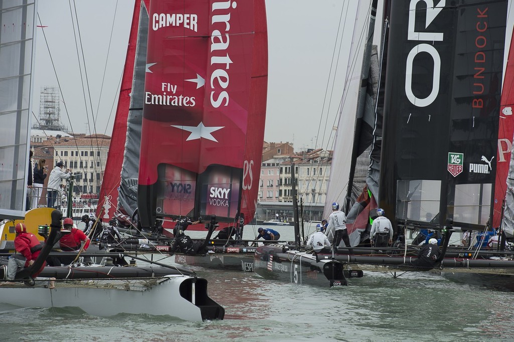The fleet attempt to sqeeze between a mark and the sea wall in the final fleet race. America’s Cup World Series Regatta Venice.  © Chris Cameron/ETNZ http://www.chriscameron.co.nz