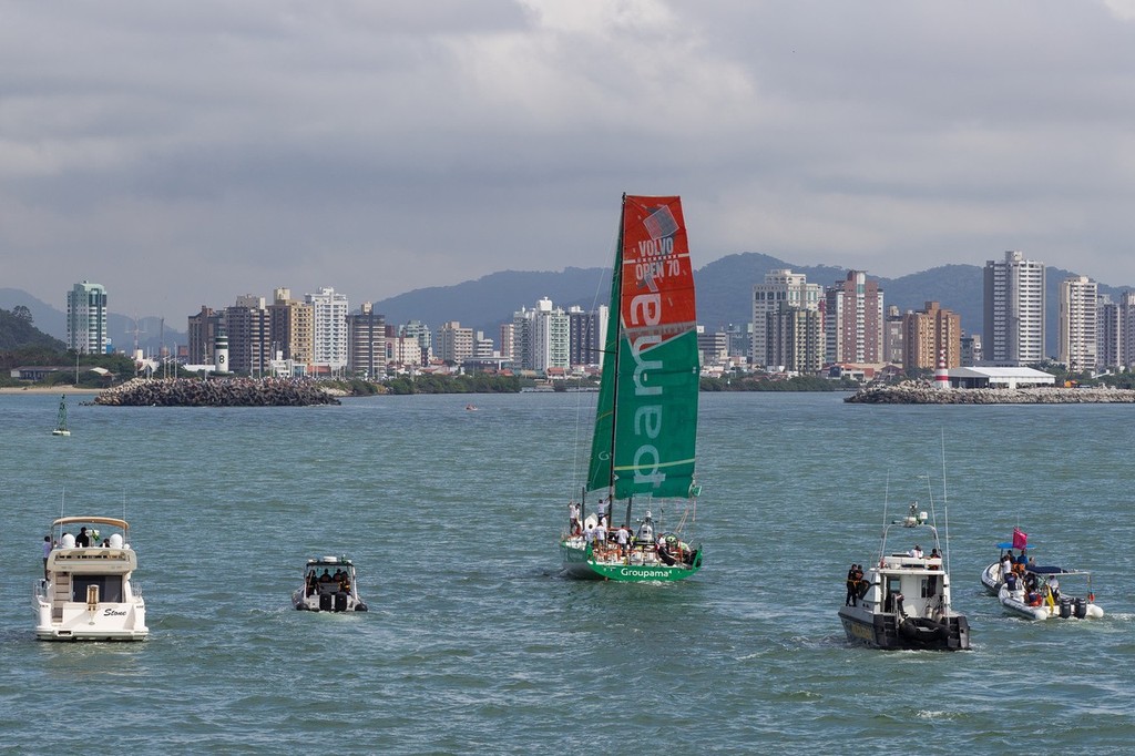 A spectator fleet follows Groupama Sailing Team, skippered by Franck Cammas from France, sailing under jury rig, as they approach the finish line in Itajai, during leg 5 of the Volvo Ocean Race 2011-12, from Auckland, New Zealand to Itajai, Brazil. (Credit: IAN ROMAN/Volvo Ocean Race) photo copyright Ian Roman/Volvo Ocean Race http://www.volvooceanrace.com taken at  and featuring the  class