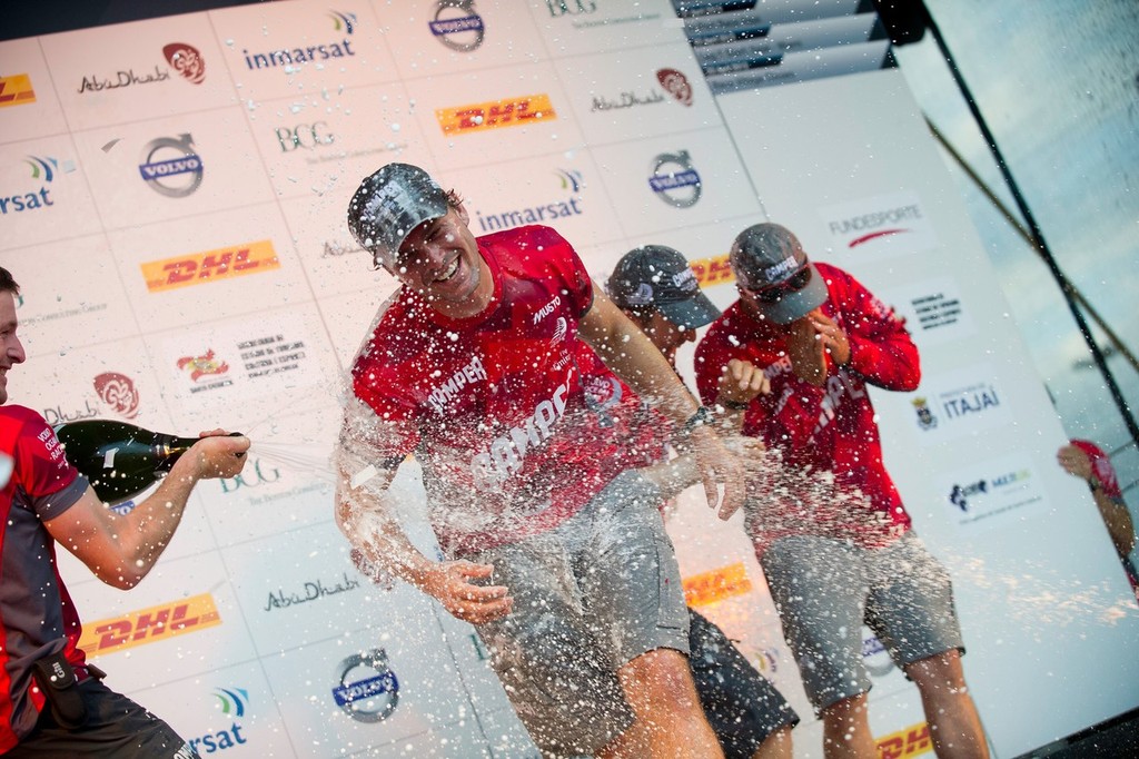 Camper’s Mike Pammenter from South Africa is sprayed with champagne as they celebrate coming second in the DHL In-Port Race Itajai, Brazil, in the Volvo Ocean Race 2011-12.  © Paul Todd/Volvo Ocean Race http://www.volvooceanrace.com