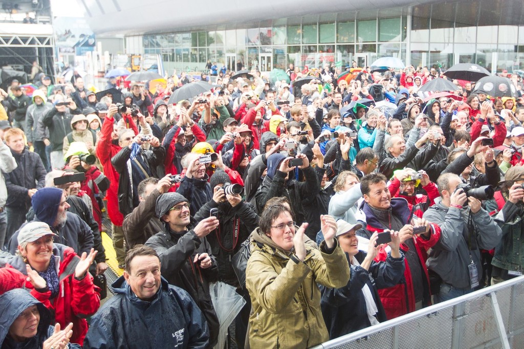 Crowds gather in the rain to see Groupama Sailing Team, skippered by Franck Cammas from France, celebrate on stage after taking first place on leg 8, from Lisbon, Portugal, to Lorient, France, during the Volvo Ocean Race 2011-12.) © Ian Roman/Volvo Ocean Race http://www.volvooceanrace.com