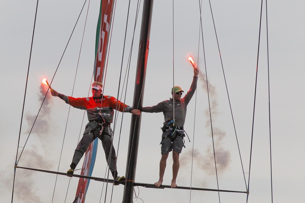 Bowmen Martin Krite and Brad Marsh spark flares as Groupama Sailing Team, skippered by Franck Cammas from France arrives into the dock, for the final public prize giving, in Galway, Ireland, during the Volvo Ocean Race 2011-12. (Credit: IAN ROMAN/Volvo Ocean Race) photo copyright Ian Roman/Volvo Ocean Race http://www.volvooceanrace.com taken at  and featuring the  class