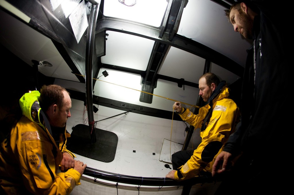 Abu Dhabi Ocean Racing&rsquo;s Justin Slattery and Craig Satterthwaite marking out the area where the crew need to make repairs, after sustaining delamination damage during leg 5 of the Volvo Ocean Race 2011-12, from Auckland, New Zealand to Itajai, Brazil.  &copy; Nick Dana/Abu Dhabi Ocean Racing /Volvo Ocean Race http://www.volvooceanrace.org