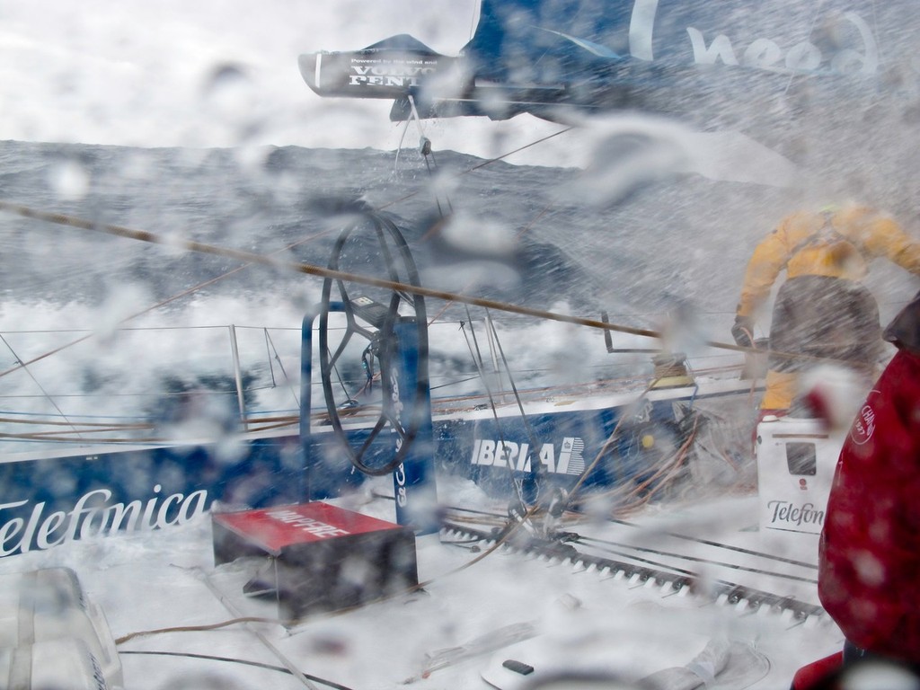 Team Telefonica crew fully suited up as the Southern Ocean sea washes over the deck, during leg 5 of the Volvo Ocean Race 2011-12, from Auckland, New Zealand to Itajai, Brazil. © Diego Fructuoso /Team Telefónica/Volvo Ocean Race http://www.volvooceanrace.com