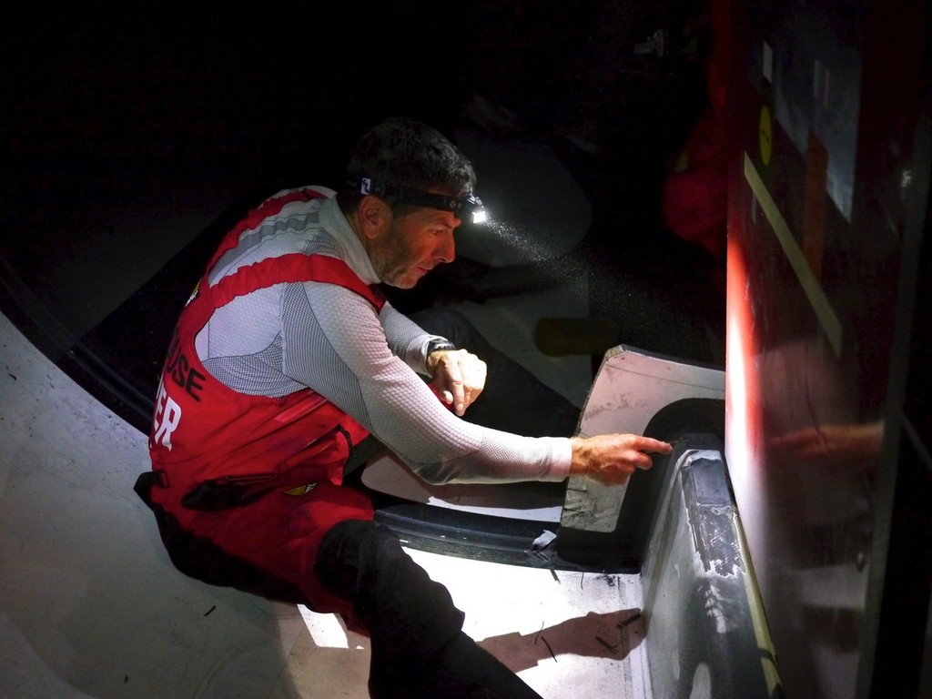 Rob Salthouse grinding back some delaminated carbon on the longitudinal, onboard CAMPER with Emirates Team New Zealand during leg 5 of the Volvo Ocean Race 2011-12, from Auckland, New Zealand to Itajai, Brazil. (Credit: Hamish Hooper/CAMPER ETNZ/Volvo Ocean Race) photo copyright Hamish Hooper/Camper ETNZ/Volvo Ocean Race taken at  and featuring the  class