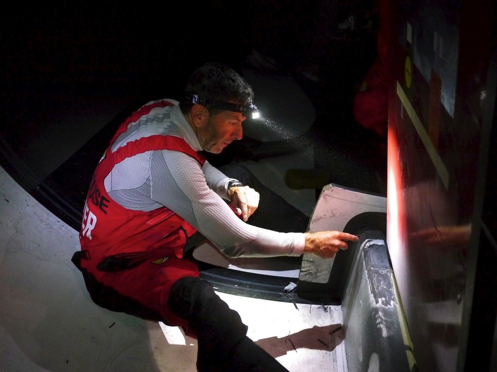 Rob Salthouse grinding back some delaminated carbon on the longitudinal, onboard Camper © Hamish Hooper/Camper ETNZ/Volvo Ocean Race