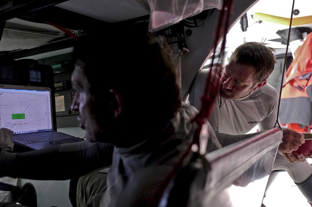 Will Oxley hard at work as TonyRae has a peak on progress onboard CAMPER with Emirates Team New Zealand during leg 7 of the Volvo Ocean Race 2011-12, from Miami, USA to Lisbon, Portugal. (Credit: Hamish Hooper/CAMPER ETNZ/Volvo Ocean Race) photo copyright Hamish Hooper/Camper ETNZ/Volvo Ocean Race taken at  and featuring the  class