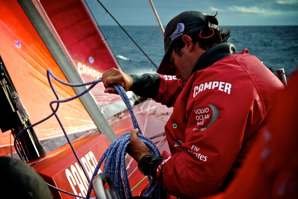 Daryl Wislang coiling the furling line onboard Camper with Emirates Team New Zealand during leg 8 of the Volvo Ocean Race 2011-12, from Lisbon, Portugal to Lorient, France.  © Hamish Hooper/Camper ETNZ/Volvo Ocean Race
