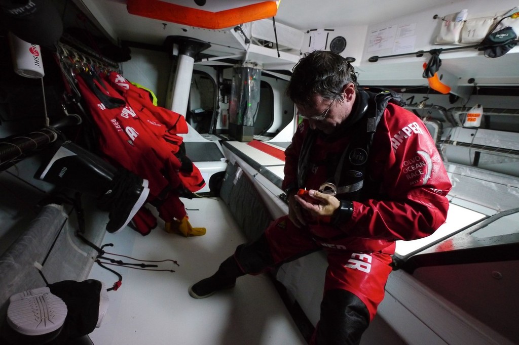 A  drenched Will Oxley steps down below after being on deck, onboard CAMPER with Emirates Team New Zealand during leg 8 of the Volvo Ocean Race 2011-12, from Lisbon, Portugal to Lorient, France. (Credit: Hamish Hooper/CAMPER ETNZ/Volvo Ocean Race) photo copyright Hamish Hooper/Camper ETNZ/Volvo Ocean Race taken at  and featuring the  class