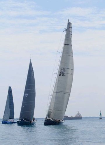 A crew member of Windquest of Macatawa Bay Yacht Club stands on the spar at the starting line Saturday, July 14, 2012, in the PHRF A Class - Bayview Mackinac Race 2012 © The Times Herald, Mark R. Rummel / AP