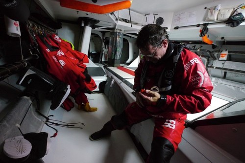 A  drenched Will Oxley steps down below after being on deck, onboard Camper with Emirates Team New Zealand during leg 8 of the Volvo Ocean Race 2011-12, from Lisbon, Portugal to Lorient, France.  © Hamish Hooper/Camper ETNZ/Volvo Ocean Race