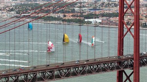 Groupama Sailing Team, skippered by Franck Cammas from France, leads the fleet as they approach the 25 de Abril Bridge, in the Oeiras In-Port Race in Lisbon, during the Volvo Ocean Race 2011-12 photo copyright Ian Roman/Volvo Ocean Race http://www.volvooceanrace.com taken at  and featuring the  class