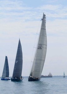 A crew member of Windquest of Macatawa Bay Yacht Club stands on the spar at the starting line Saturday, July 14, 2012, in the PHRF A Class - Bayview Mackinac Race 2012 photo copyright The Times Herald, Mark R. Rummel / AP taken at  and featuring the  class