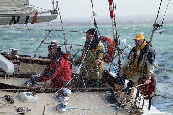 Robin Hewitt behind the helm has taken Yoko on many voyages. Trevor Huggard (yellow cap) been there too. - Helly Hansen Winter Series ©  Alex McKinnon Photography http://www.alexmckinnonphotography.com