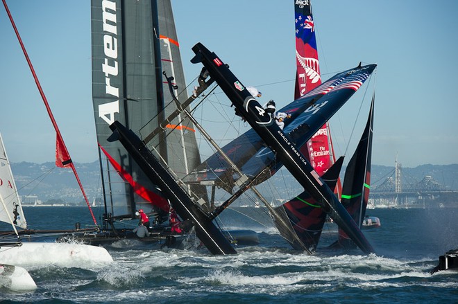 Oracle Team USA digs the bows in and capsizes at the first mark in the first fleet race of day four of the America’s Cup World Series, San Francisco.  ©  SW