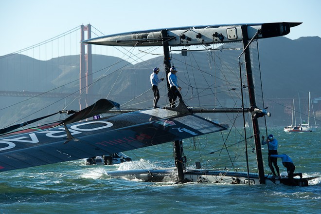 Oracle Team USA digs the bows in and capsizes at the first mark in the first fleet race of day four of the America’s Cup World Series, San Francisco.  ©  SW