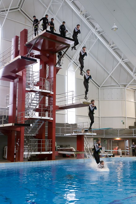 Emirates Team New Zealand AC72 sailors practice safety procedures in the Henderson West Wave dive pool. Rob Waddell jumping from the 10M platform. 7/11/2012 © Chris Cameron/ETNZ http://www.chriscameron.co.nz