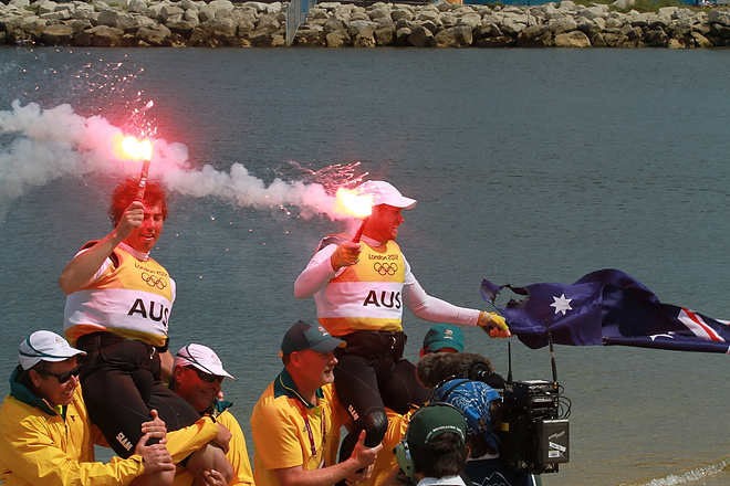 Olympic Games Sailing at Weymouth, Dorset August 2012. Australia’s Nathan Outteridge (helmsman in baseball cap) and Ian Jensen celebrate winning gold in the 49er class at the London Olympics. © Ingrid Abery http://www.ingridabery.com