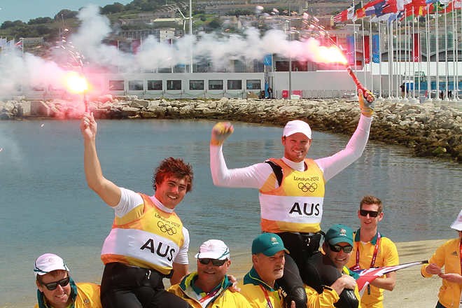 Olympic Games Sailing at Weymouth, Dorset August 2012. Australia’s Nathan Outteridge (helmsman in baseball cap) and Ian Jensen celebrate winning gold in the 49er class at the London Olympics. © Ingrid Abery http://www.ingridabery.com
