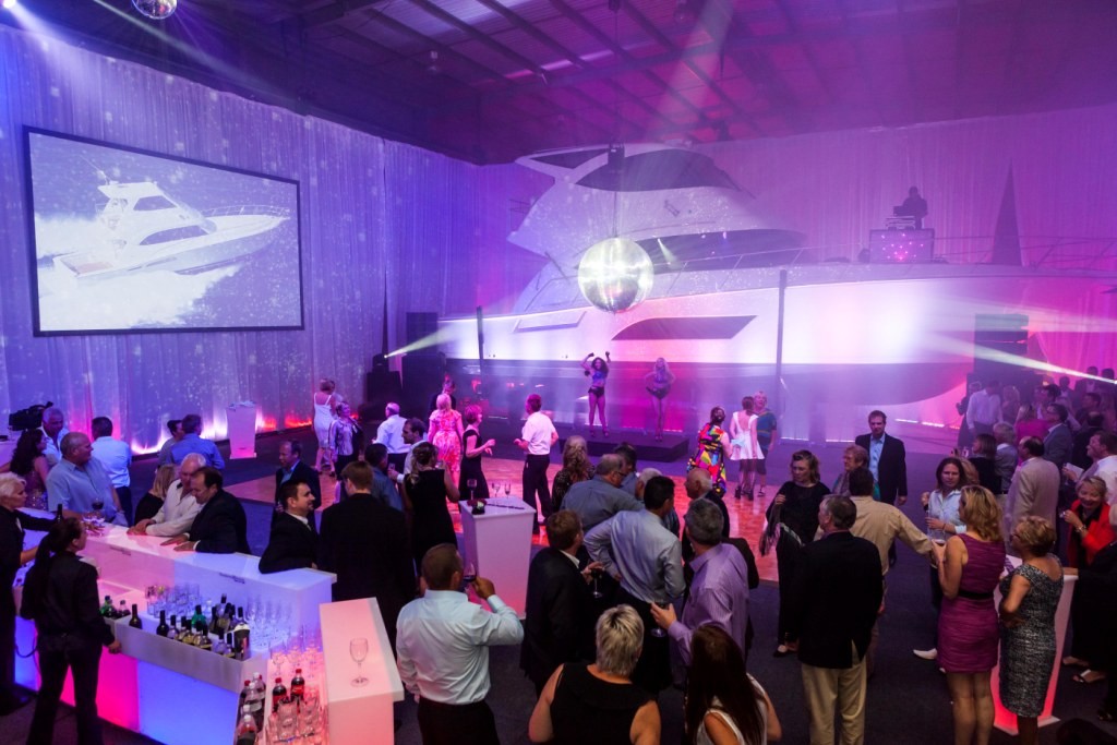 A huge mirrored disco ball set the scene for the Riv nightclub in the factory as a slide show portrayed Riviera's 32 year history photo copyright Stephen Milne taken at  and featuring the  class