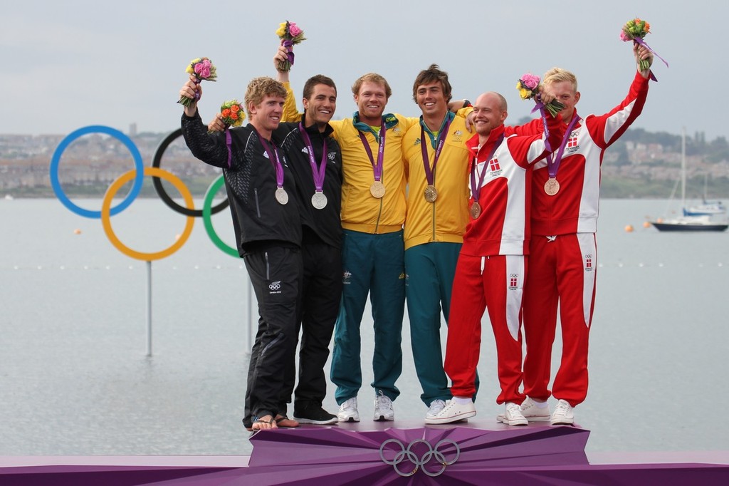  August 8, 2012 - Weymouth, England -49er Medal presentation -from left Peter Burling, Blair Tuke (NZL), Nathan Outteridge, Iain Jensen  (AUS), Allan Norregaard and Peter Lang (DEN). Who else but a NZer would wear jandals on on an Olympic podium? © Richard Gladwell www.photosport.co.nz