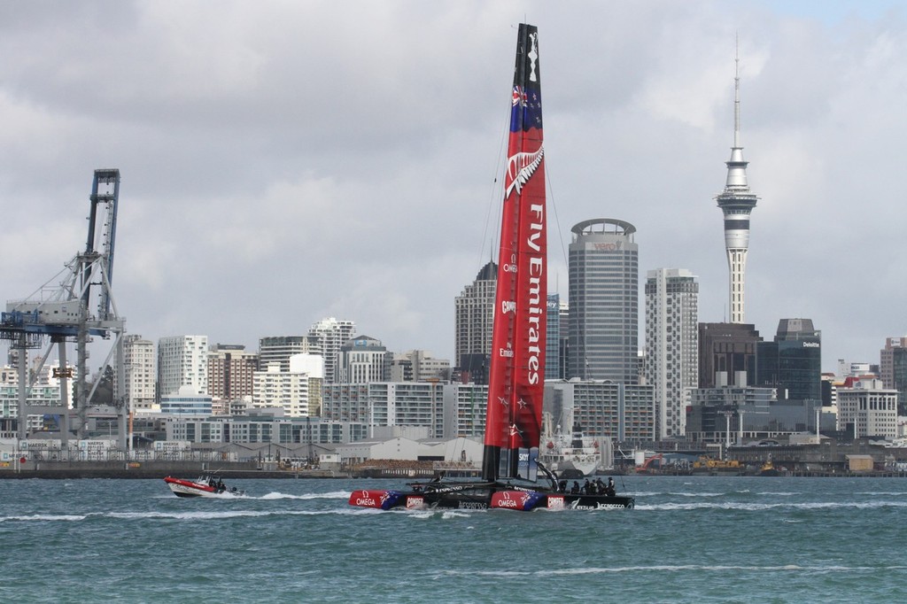 Emirates Team NZ’s AC72  tows out of the Waitemata past Auckland’s iconic Skytower © Richard Gladwell www.photosport.co.nz