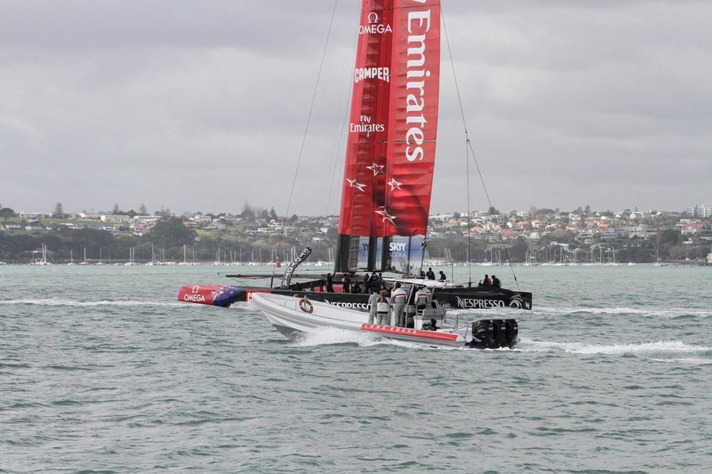 Emirates Team NZ’s AC72  tows out of the Waitemata Harbour with Luna Rossa’s tender in pursuit © Richard Gladwell www.photosport.co.nz