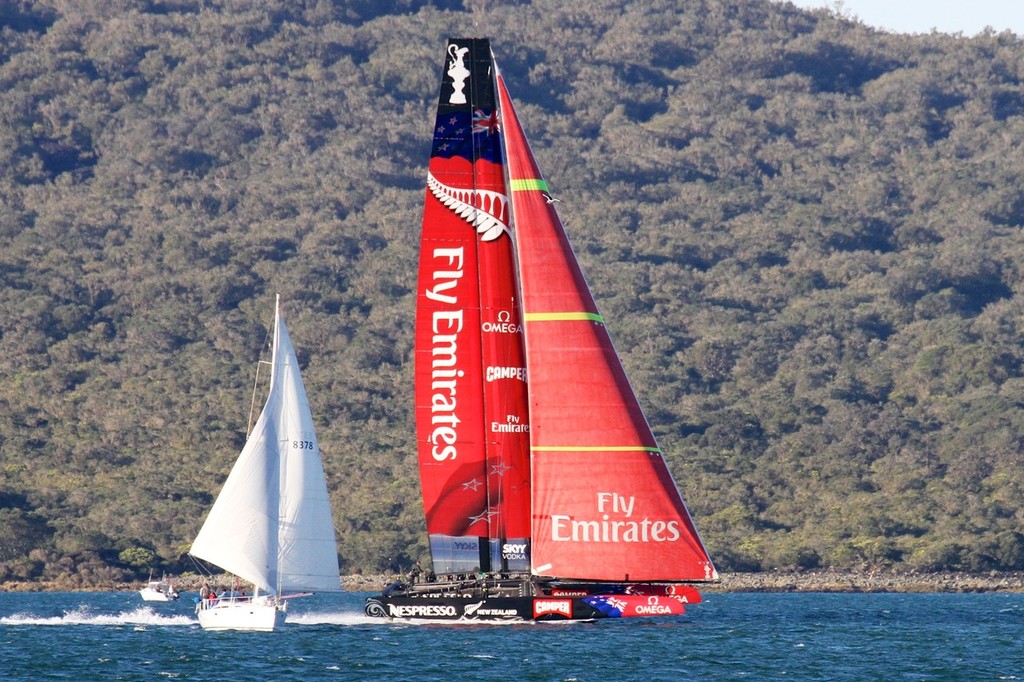 IMG 8302 Flying down the back of Rangitoto. Note gennaker is fully sheeted and set. Goosewinged yacht indicates wind direction. Sea state indicates 12-14kt breeze. Boat speed estimated at 30kts - Emirates Team NZ September 14, 2012 © Richard Gladwell www.photosport.co.nz